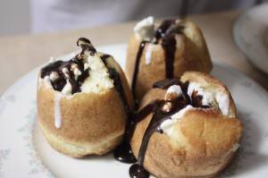 Popovers stuffed with ice cream and drizzled with chocolate