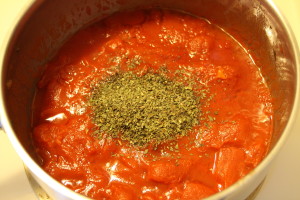 adding basil to sauce