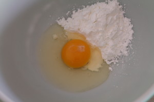 Whisk in a egg at a time. Why? We don't know, but we did it anyway. It probably ensures that the cornstarch is thoroughly mixed in.