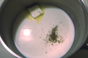 Bring a cup of cream, butter, salt, and pepper to a simmer. Simmer until reduced to 2/3 cup.