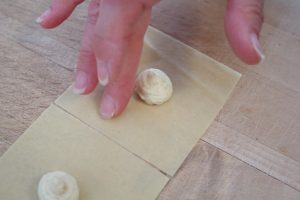 moisening a pasta sheet